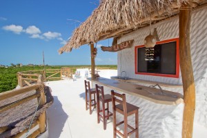The bar and patio area included with the Palapita del Amor room.
