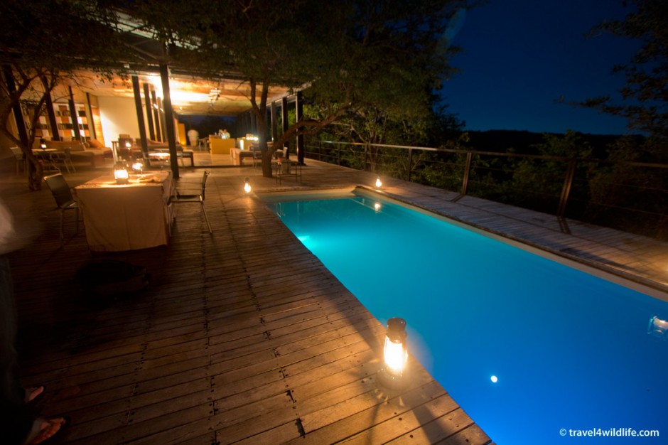 The beautifully designed pool, sitting area, bar, and dining area at the Outpost.