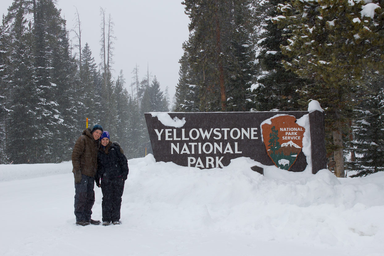 Us posing in front of the Yellowstone sign in the snow