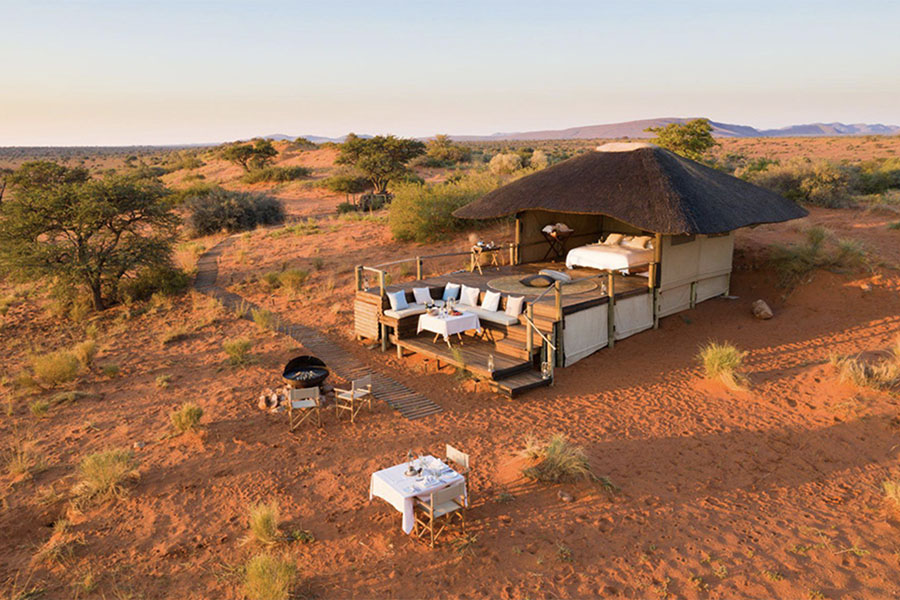 a safari suite with outdoor sleeping on red sands in the Kalahari 
