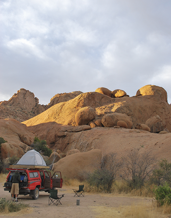 truck and a tent by big boulders