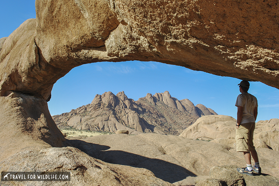 natural bridge with person standing under it