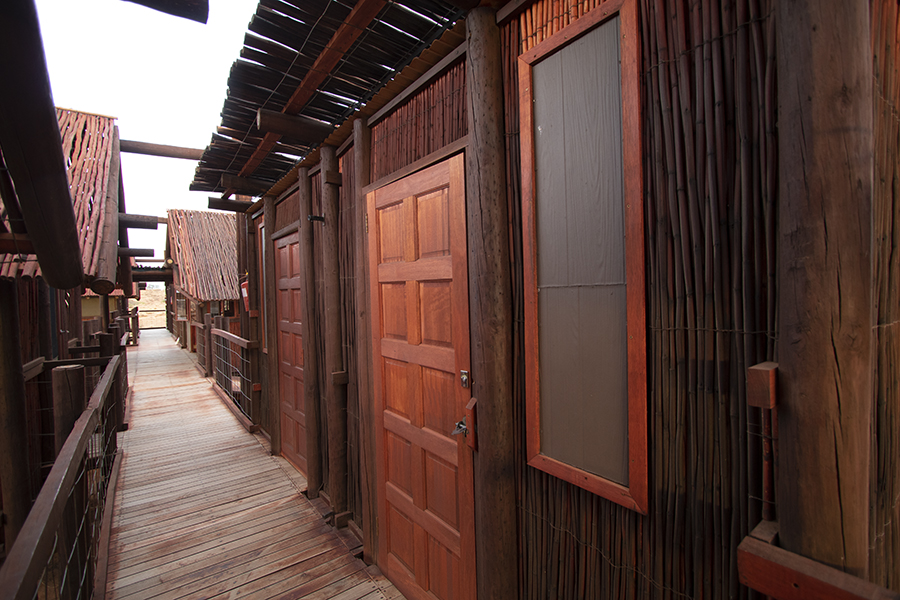 wooden walkway with the bathroom doors