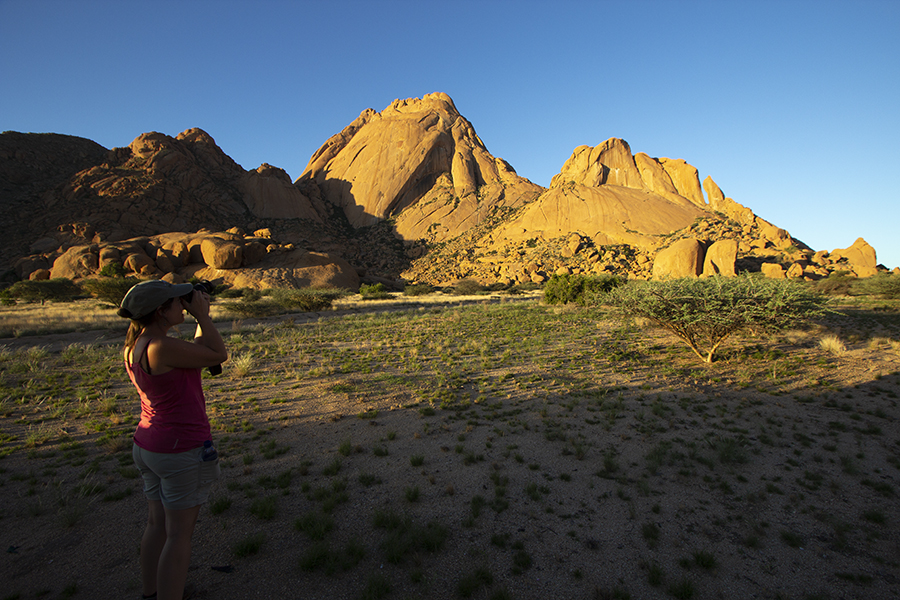 woman taking a photo at sunset