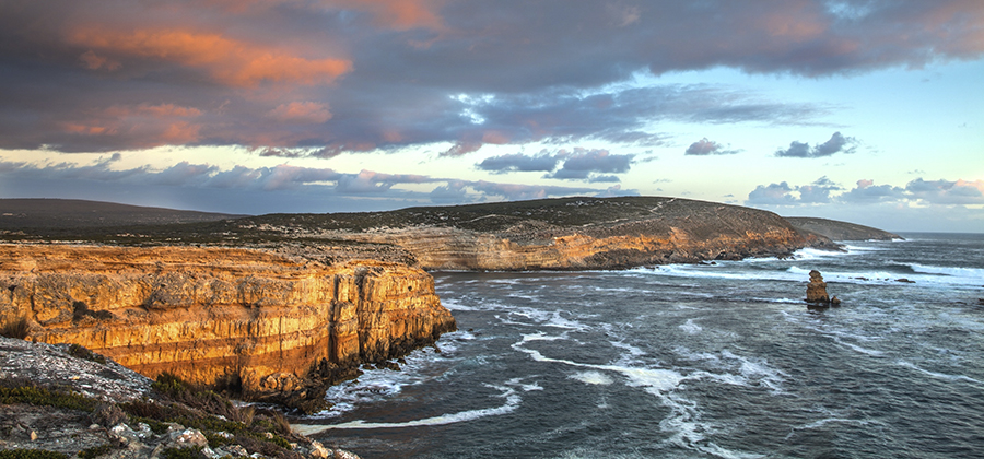 sea cliffs with orange sunset light