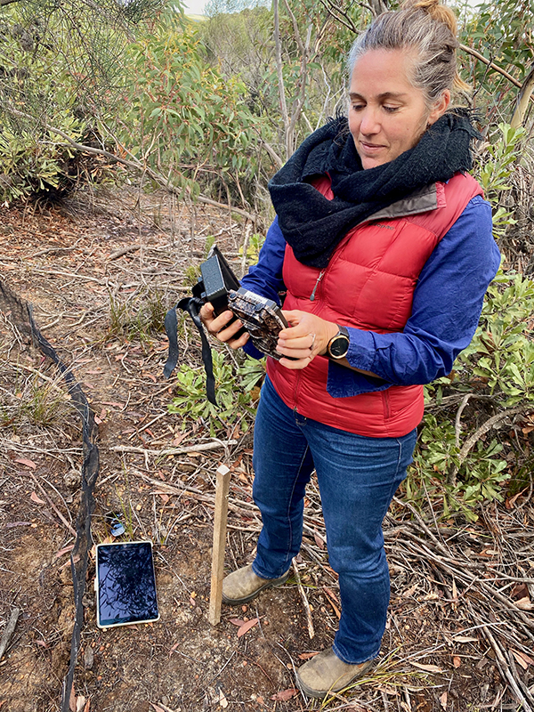 woman checking trail camera