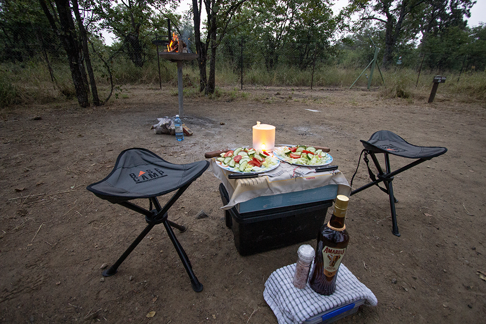 table and two camp chairs at a camping spot