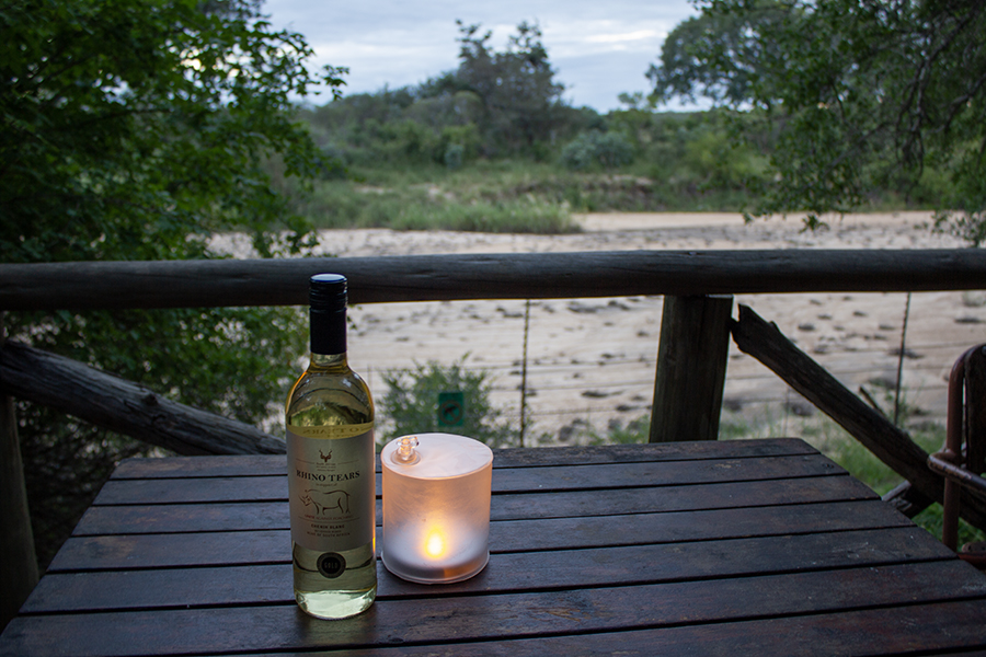 wooden deck overlooking a dry river.