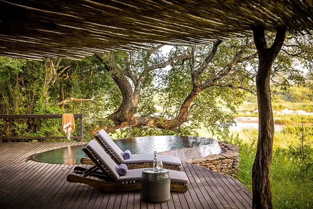 pool and two chairs with views of the savannah during green season