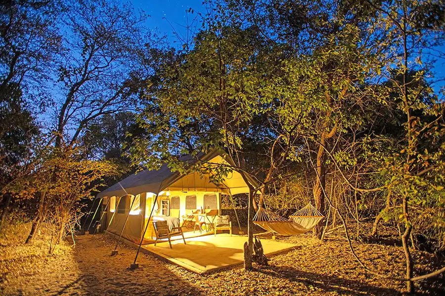 safari tents at night at Tsowa safari island lodge