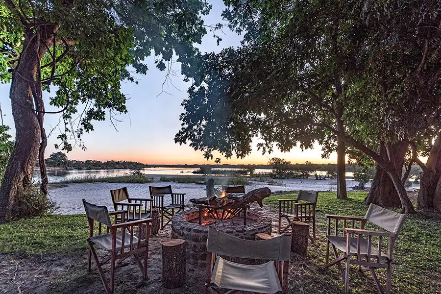 chairs and fire pit overlooking river